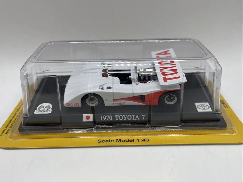 1:43 scale Toyota 7 race car model in clear display box, red and white.