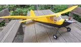 Yellow high-wing RC airplane model with landing gear and prop