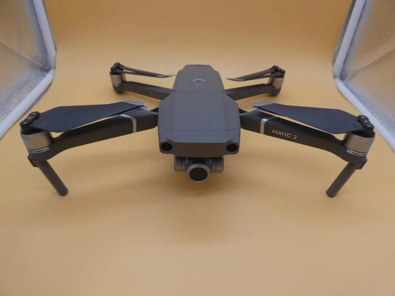 Gray dummy quadcopter drone model with front camera and four rotors