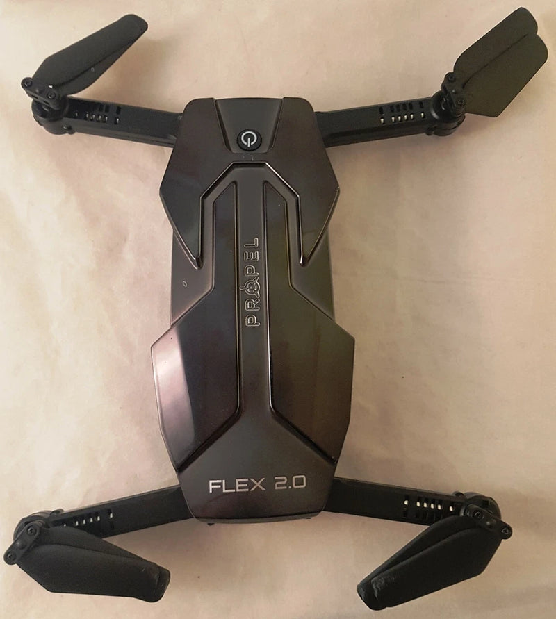 Black folding RC drone body with FLEX 2.0 center module and four propeller arms