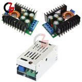 Step-down buck converter module with green PCB, copper coils, blue terminal blocks, heatsink