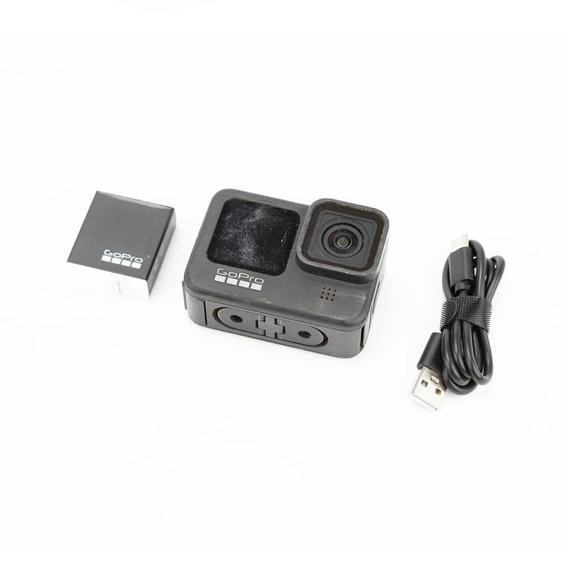 GoPro HERO9 Black action camera with front lens, display, and USB charging cable