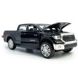 Black diecast pickup truck model car with open hood and detailed grille