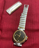 Dunhill Millennium unisex wristwatch with black dial, gold-tone bezel, metal link bracelet
