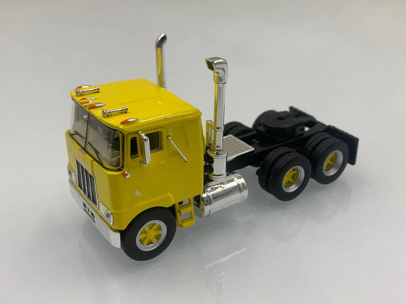 Yellow Mack F700 die-cast tractor model, 1/64 scale