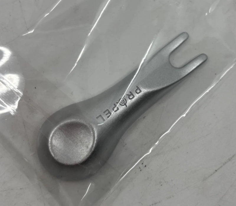 Dark gray drone propeller blade with small printed markings along the edge