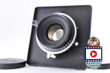 Black camera lens with front glass element, in protective case