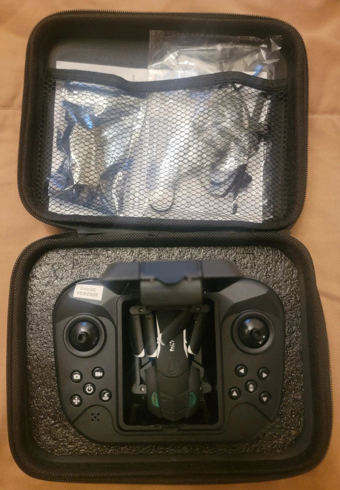 Black drone with camera inside hard carry case with mesh window