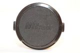 Nikon 52mm vintage black camera lens cap with embossed logo and metal tabs