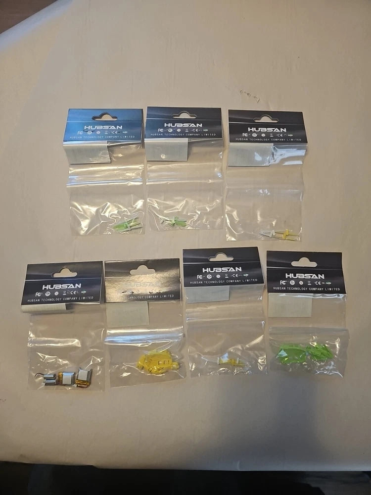 Hubsan Nano Q4 H111 parts kit in sealed blister packs with yellow and green components
