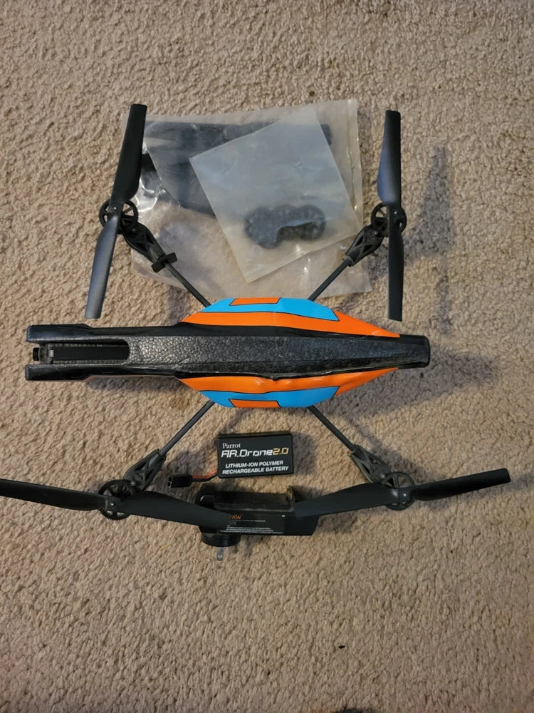 Parrot AR.Drone 2.0 quadcopter with orange and blue body and four propeller arms