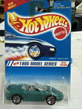 Green Hot Wheels Camaro convertible die-cast toy car in blister pack