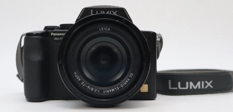 Panasonic Lumix digital bridge camera with front lens and black body