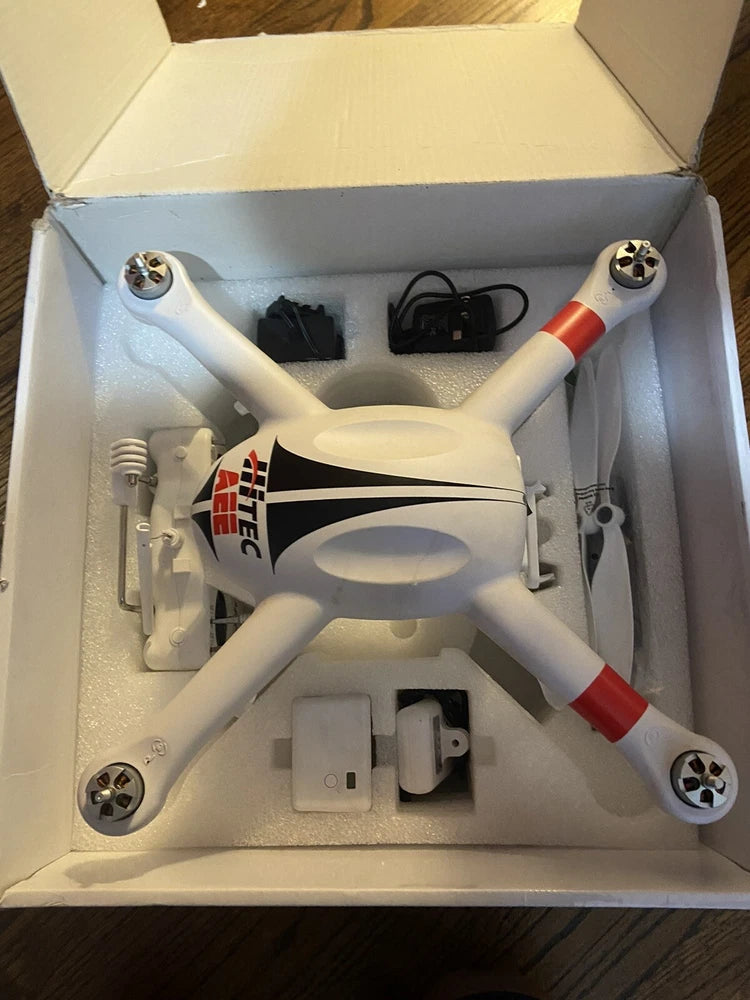 White quadcopter drone with orange-red accents and four propellers