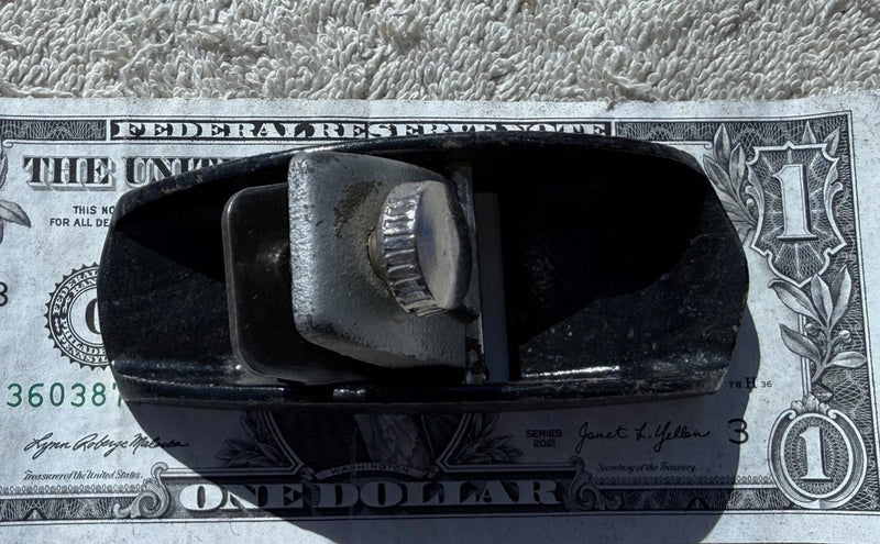 Guillow's small hobby plane with metal blade, dark body and curved base