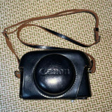 Canon vintage black leather camera case with carrying strap and Canon logo