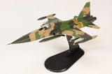 Camouflaged F-5A fighter jet model on black display stand, green and brown.