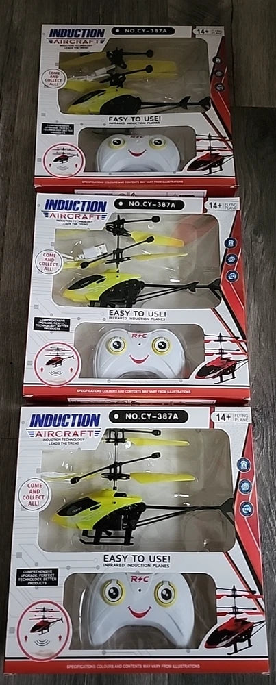 Induction RC aircraft drone in retail box, green toy with smiling face