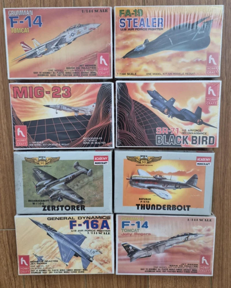 Set of 8 unopened 1:144 fighter jet model kit boxes, aircraft artwork on fronts.