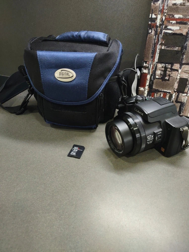 Blue and black camera case with compact camera and small memory card