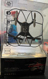 Black quadcopter drone with four propellers and small video camera, retail package shown