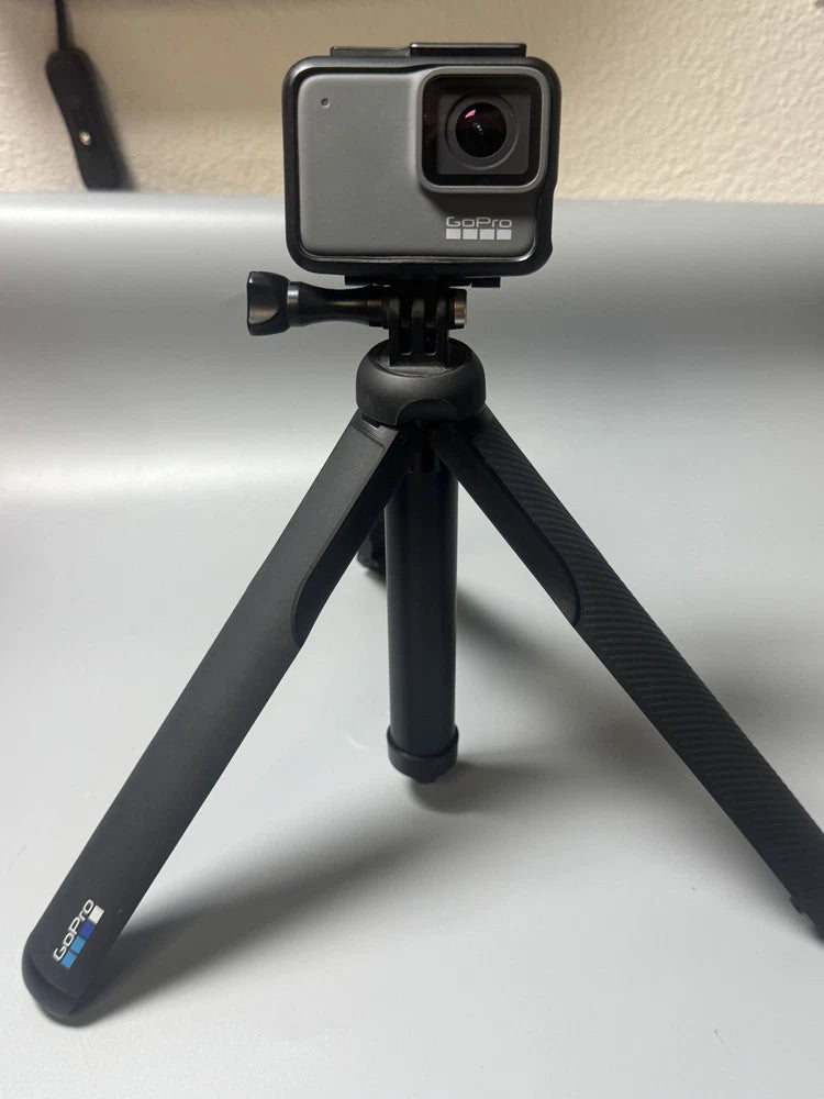 GoPro action camera on black tripod, front lens visible, compact rugged housing
