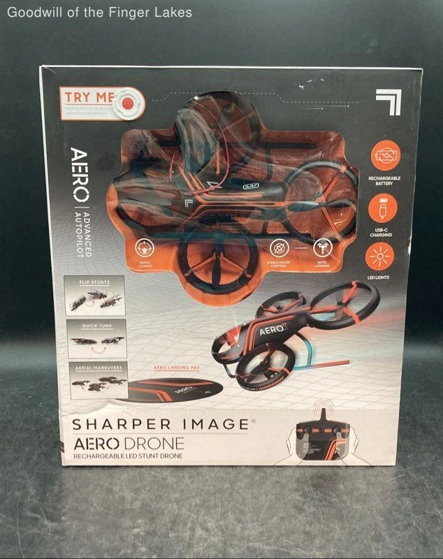 Sharper Image AERO rechargeable LED stunt drone retail box with orange and black drone