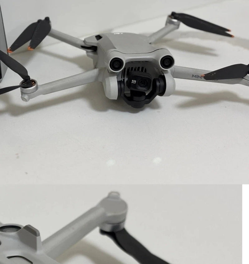 DJI Mini 3 Pro drone with four propellers, front camera module visible