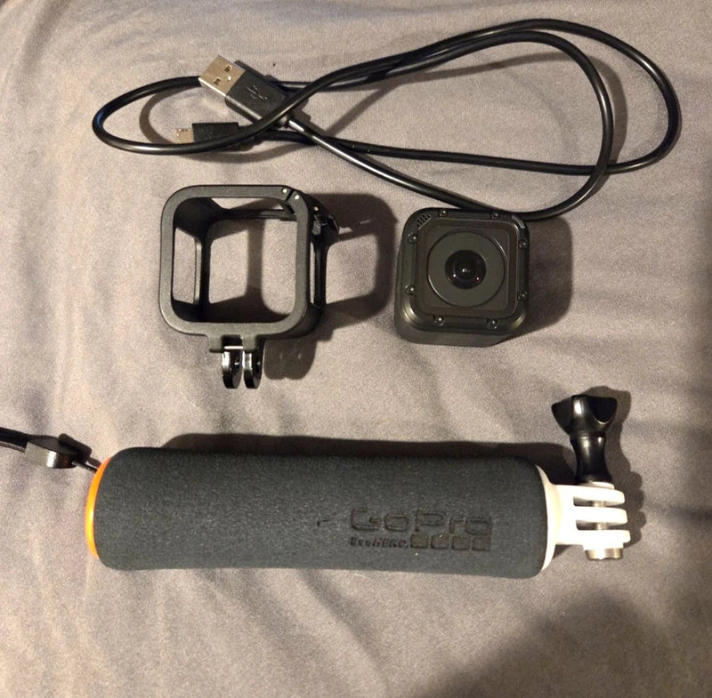 GoPro action camera with waterproof housing, mounting frame, USB cable and grip handle
