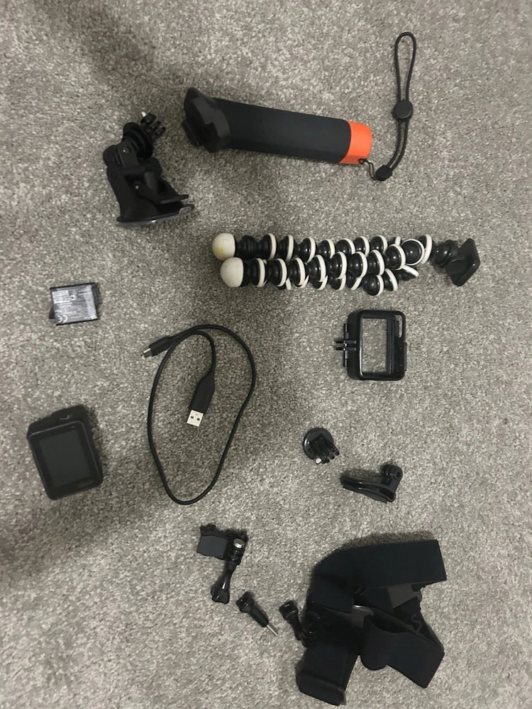 GoPro action camera bundle with mounts, cable, case, lens cap, and accessory pieces
