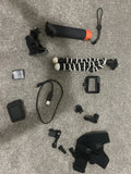 GoPro action camera bundle with mounts, cable, case, lens cap, and accessory pieces