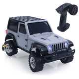 Mini 4WD RC off-road crawler car in gray with front lights and handheld remote