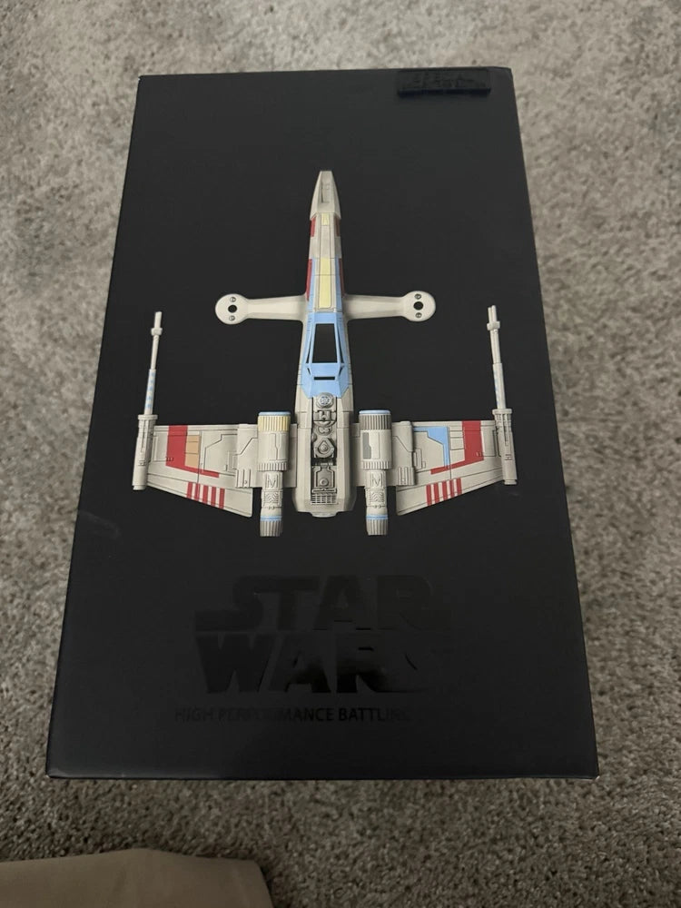 X-wing battle drone model on black collector display card, gray and white