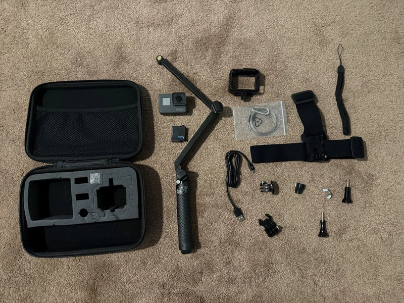 GoPro HERO5 action camera bundle with black case, mounts, strap, and batteries