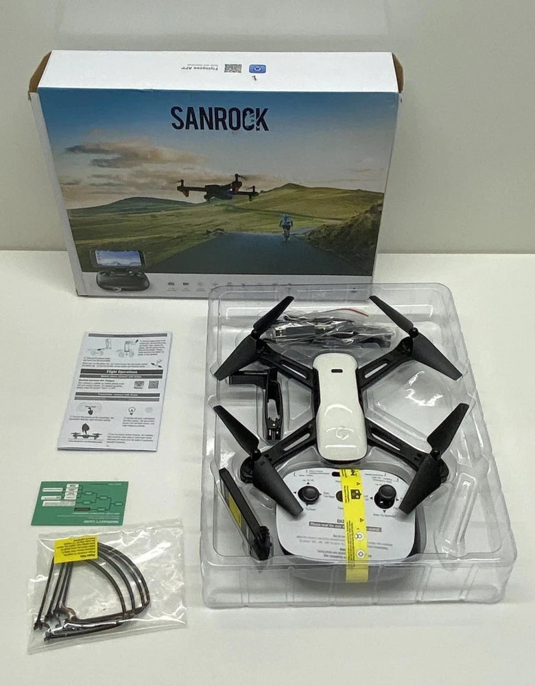 Foldable black quadcopter drone with built-in camera, retail packaging included