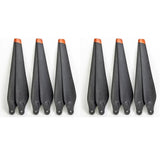 Agricultural drone propeller set with black blades and orange tip guards