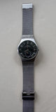 Skagen men’s wrist watch with gray mesh band and round silver case, black dial
