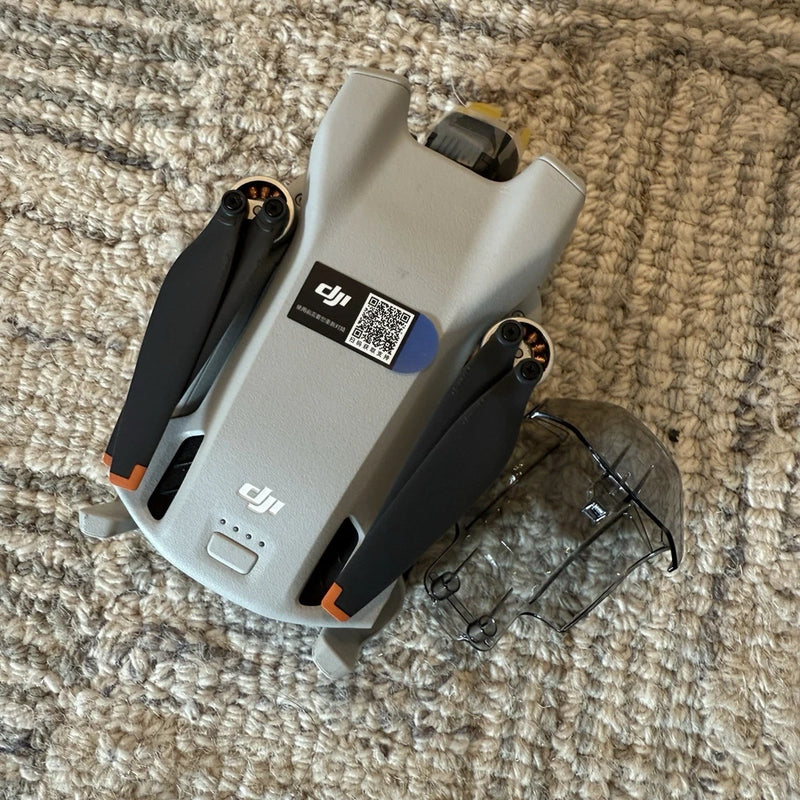 DJI Mini 3 camera drone body with folded arms, gray housing and front sensors