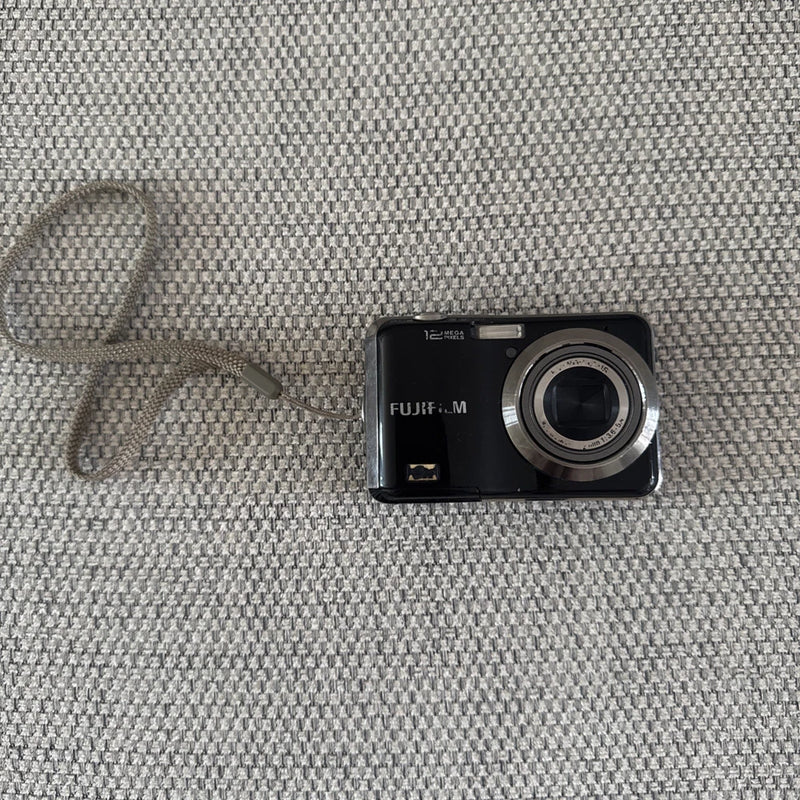Fujifilm FinePix digital camera with front lens and buttons, black body