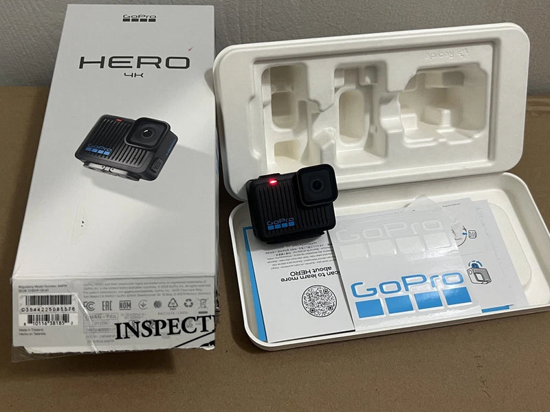 GoPro HERO 4K action camera in box, with flashing red status light