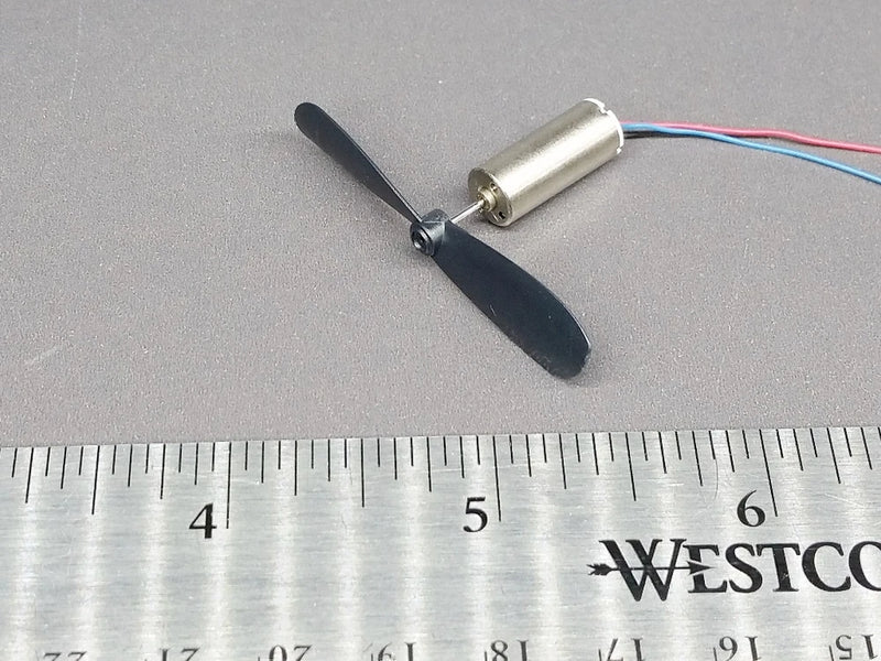 Mini DC motor with two-blade propeller, silver can with black blades and red/blue wires