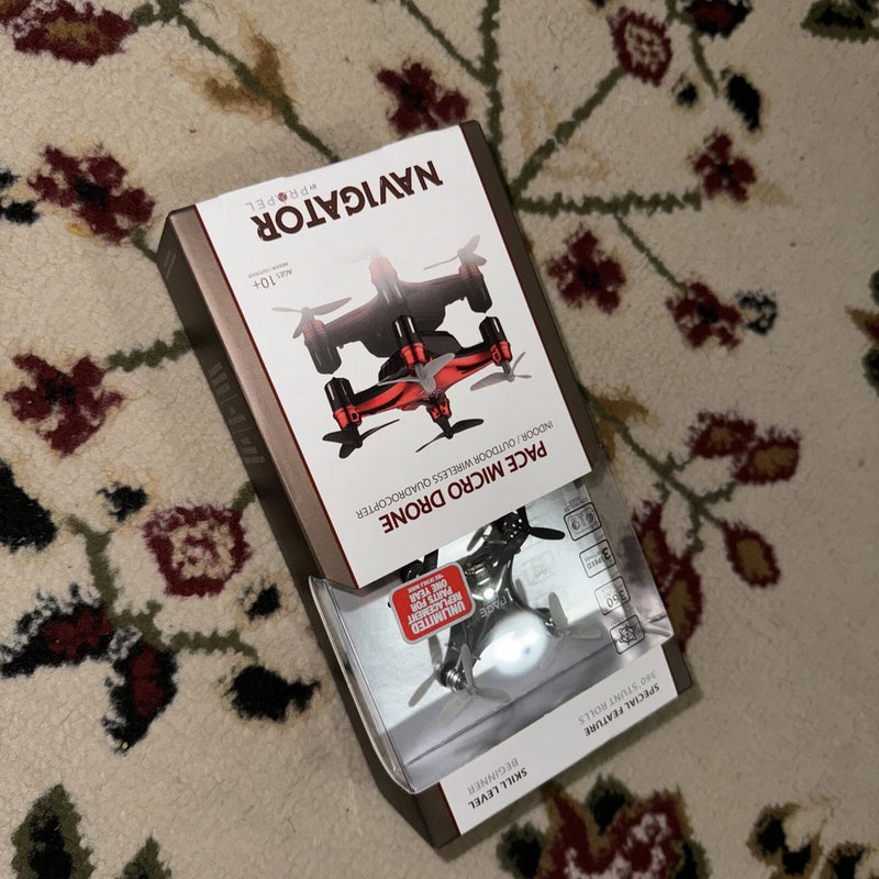 Micro drone retail box with quadcopter illustration, black and red accents