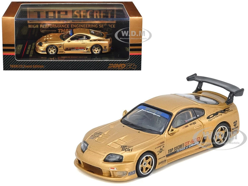 Gold die-cast sports car model with hood open, black wheels, and decals