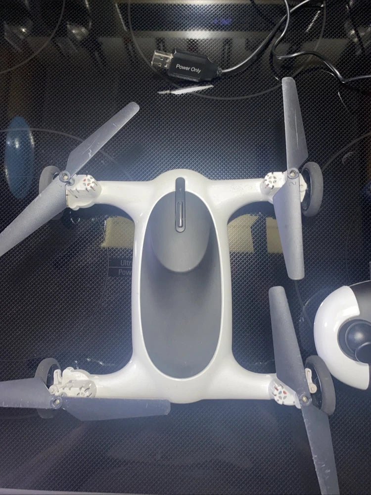 White drone with four propellers and central control module