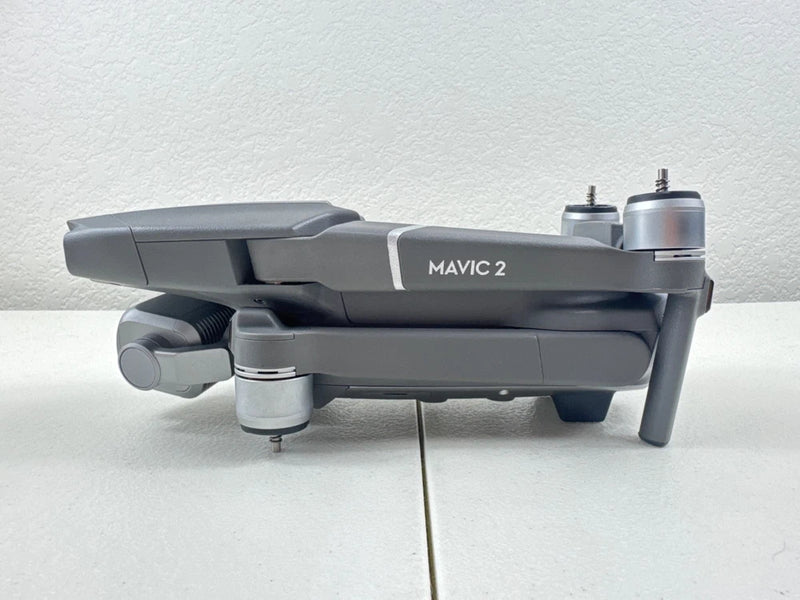 Gray quadcopter drone with front gimbal camera and extended arms