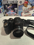 Fujifilm digital camera with attached lens and black wrist strap