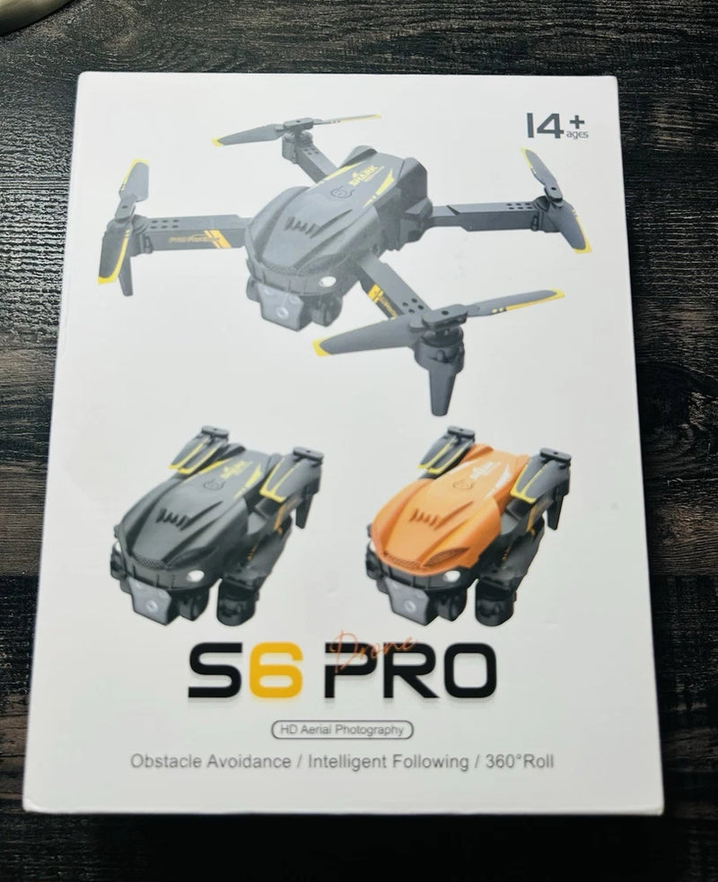 Foldable quadcopter drone box showing black and orange drone views