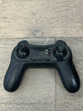 Black quadcopter game controller with twin thumbsticks and trigger buttons