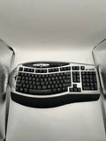 Ergonomic wireless keyboard with black keys and curved wrist rest