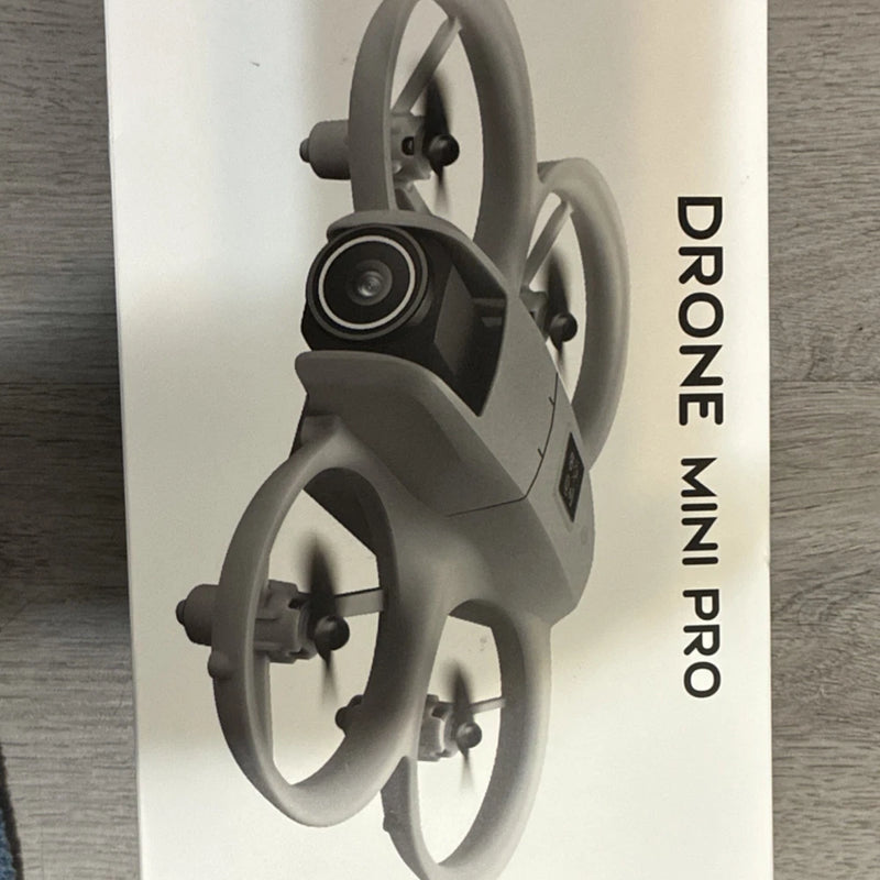 Mini drone with front camera, gray body and foldable propellers